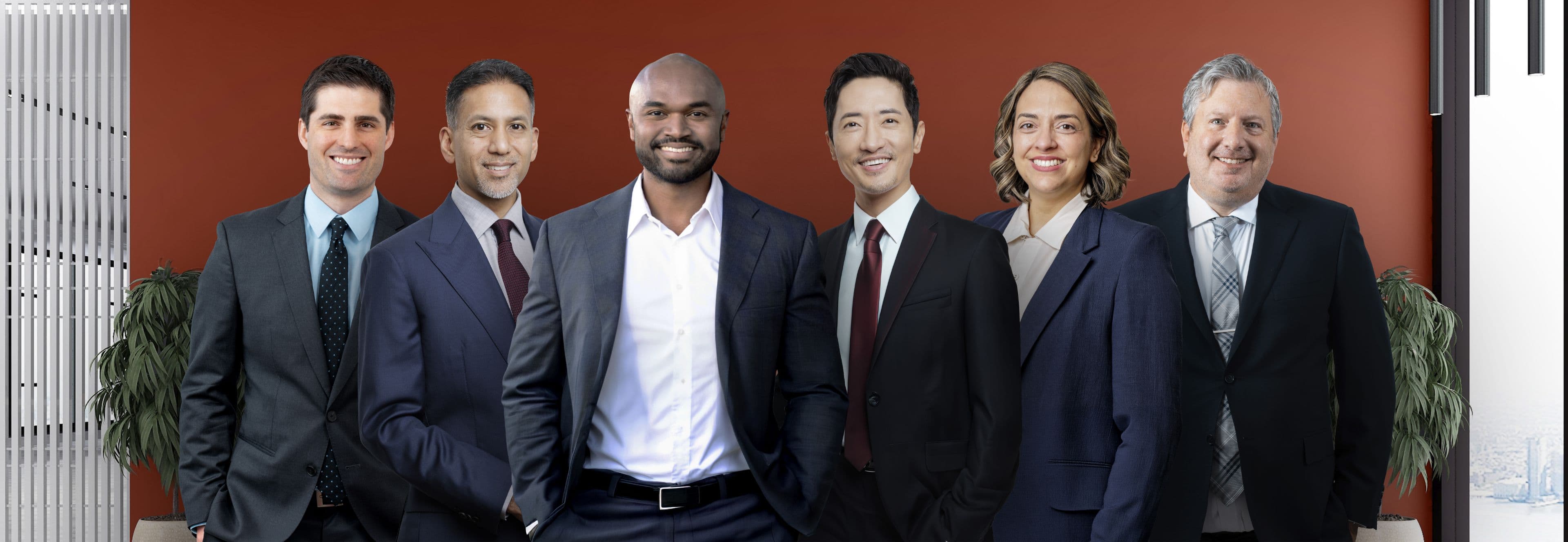 A group of surgeons in suits standing together in a modern office setting