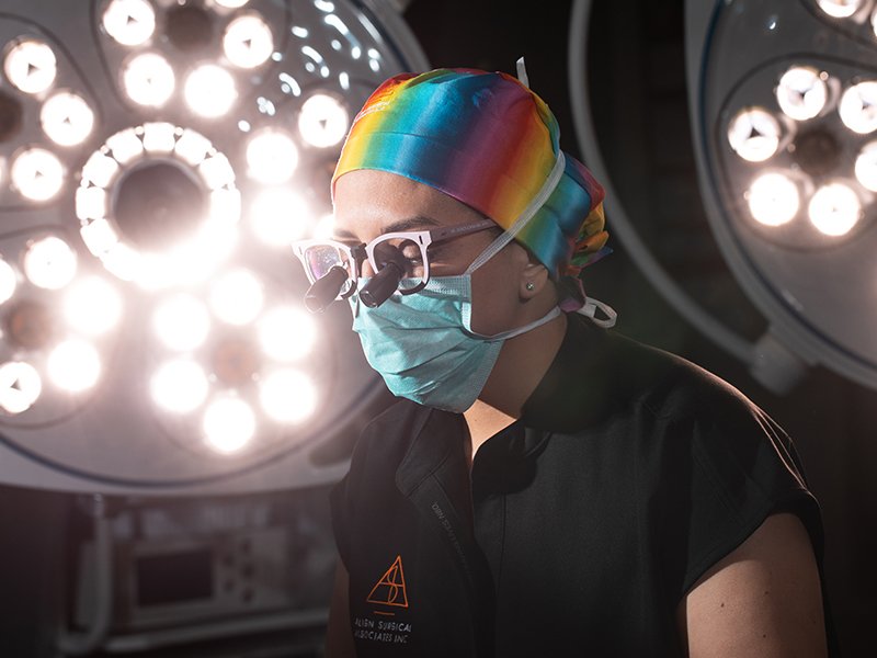 Photo of Dr. Jedrzejewski in a rainbow scrub cap