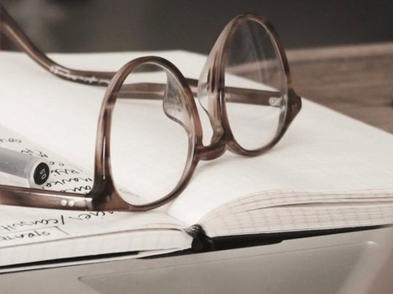 Photo of reading glasses on an open notebook