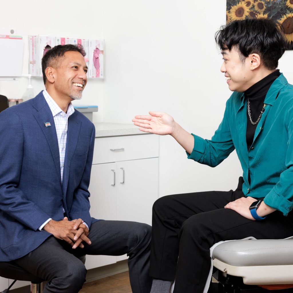 Dr. Gurjala speaking with a patient during a consultation in a medical exam room