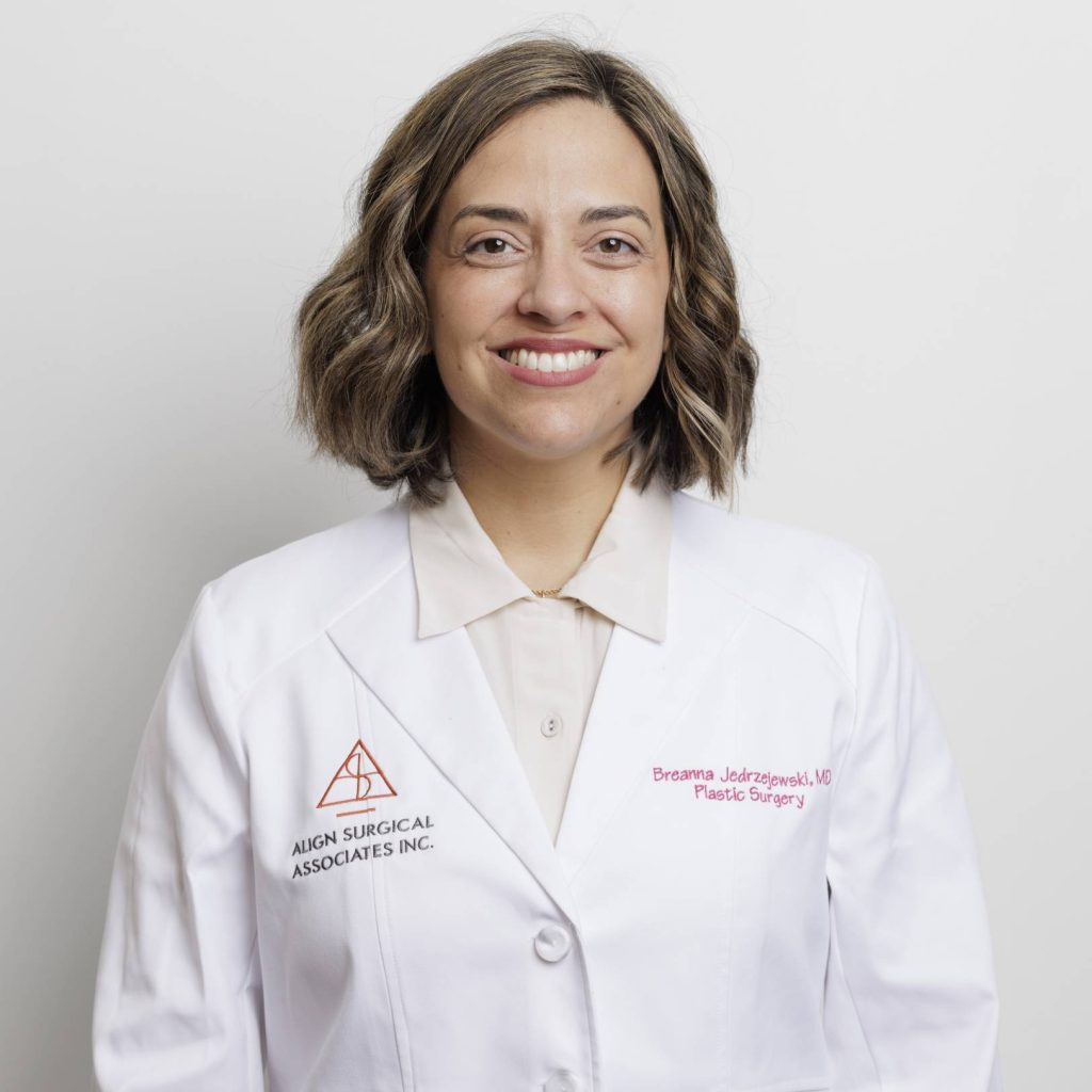 Professional portrait of Dr. Jedrzejewski in a white medical coat