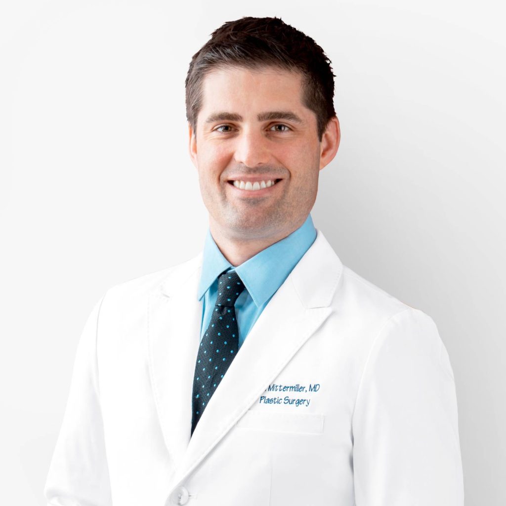 Professional portrait of Dr. Mittermiller smiling in a white medical coat
