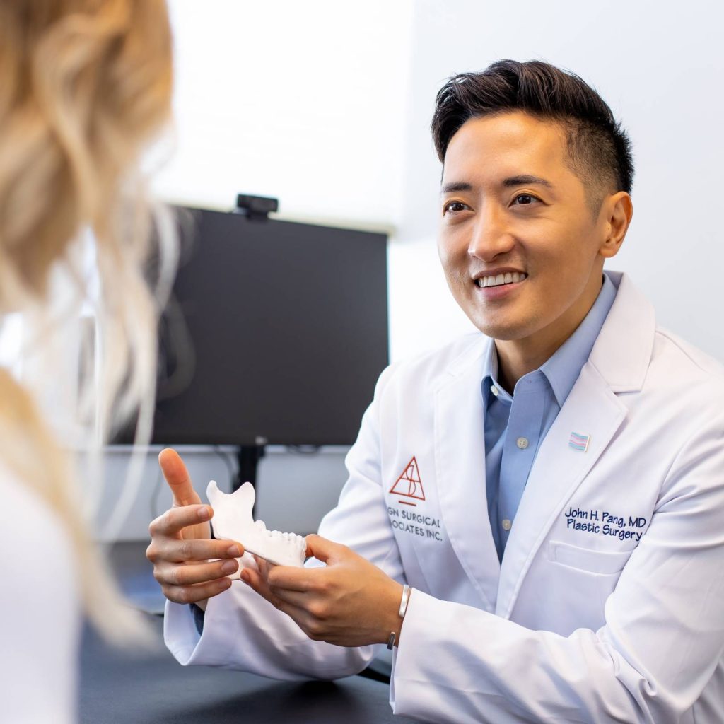 Dr. Pang discussing treatment options with a patient in a consultation room