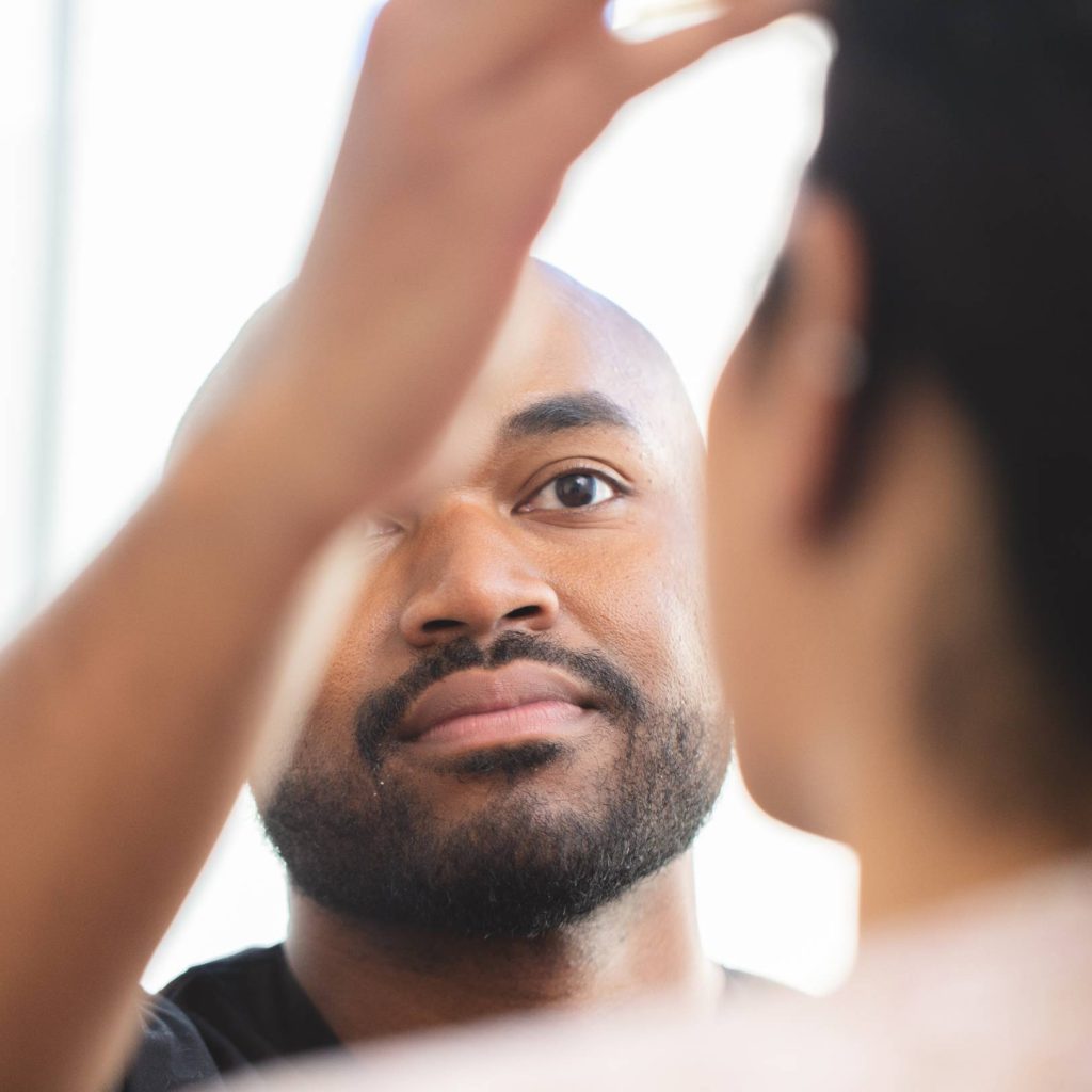 Dr. Satterwhite examining a patient's face during a consultation