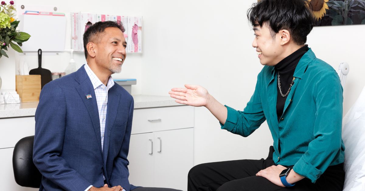 Dr. Dev Gurjala of Align Surgical Associates speaking with a patient during an in-office consultation.